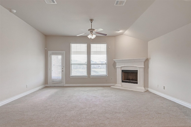 unfurnished living room with vaulted ceiling, ceiling fan, and light carpet