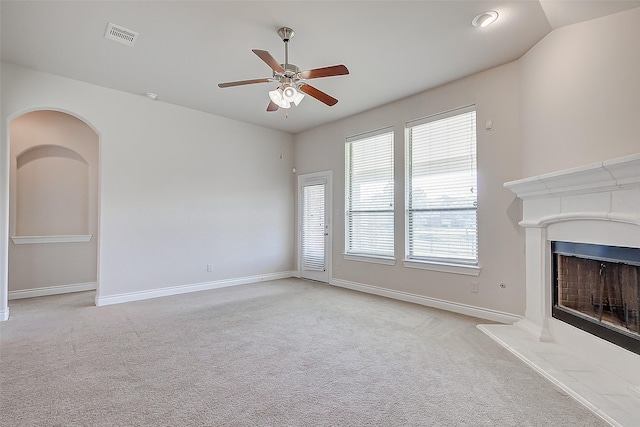 unfurnished living room with ceiling fan and light carpet