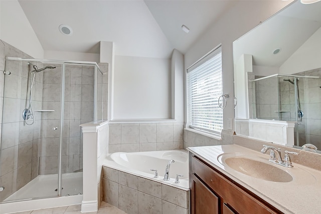 bathroom with vanity, separate shower and tub, vaulted ceiling, and plenty of natural light