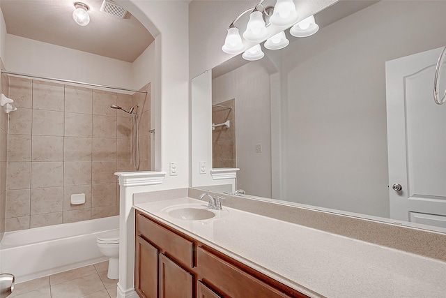 full bathroom featuring toilet, tiled shower / bath combo, tile patterned flooring, and vanity