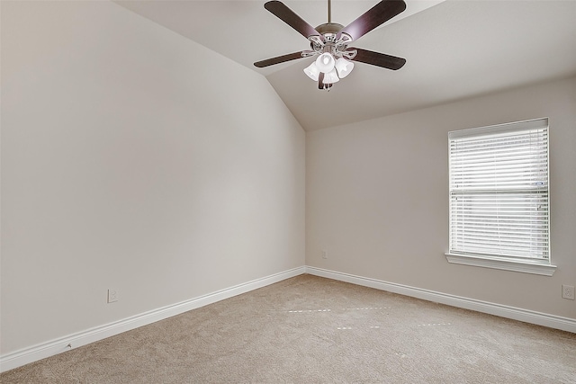 empty room featuring vaulted ceiling, light carpet, and plenty of natural light