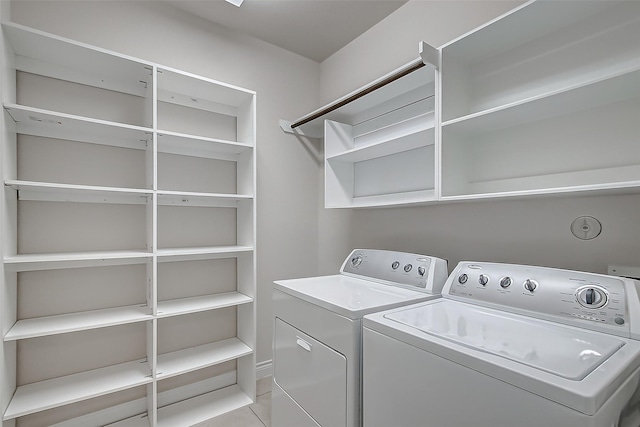 laundry room featuring washer and clothes dryer and light tile patterned floors