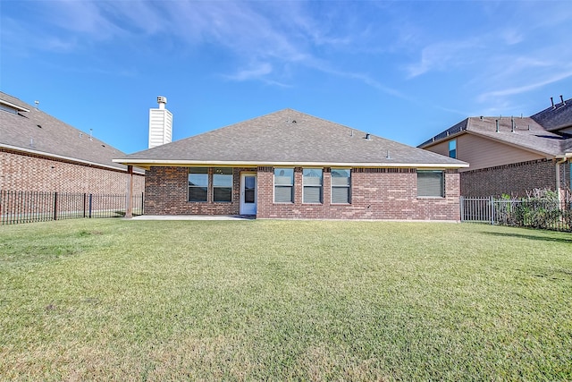 rear view of house featuring a patio and a lawn