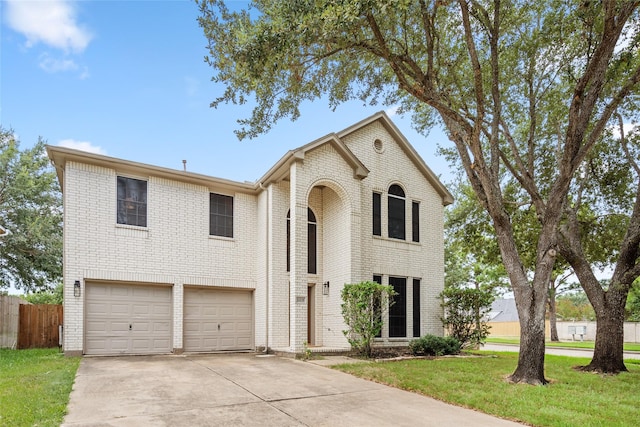 view of front of property featuring a front yard and a garage