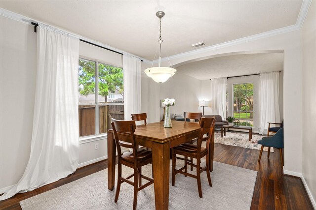 dining room featuring crown molding and dark hardwood / wood-style floors