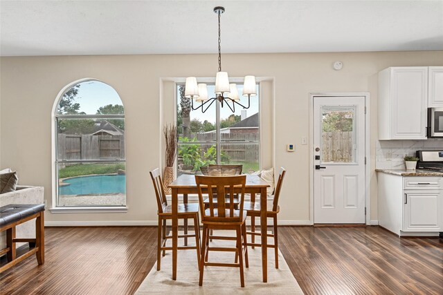 dining room featuring a notable chandelier and dark hardwood / wood-style flooring