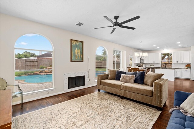 living room with sink, a wealth of natural light, and a fireplace