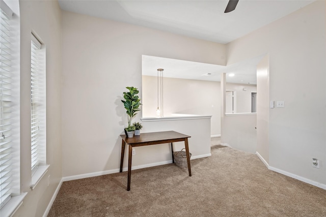 hallway featuring light colored carpet