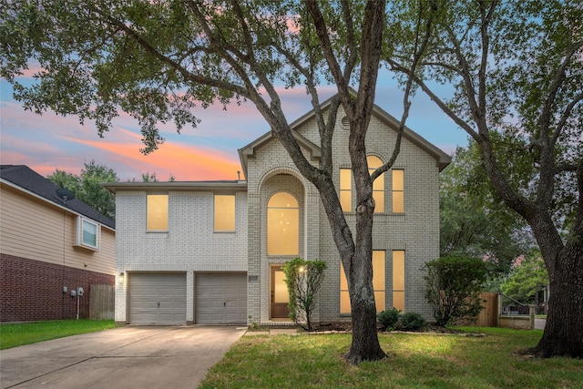 view of front of property with a yard and a garage