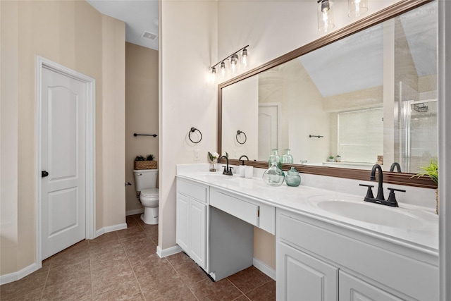 bathroom with tile patterned floors, vanity, and toilet