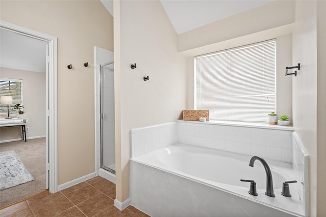 bathroom with lofted ceiling, tile patterned flooring, and separate shower and tub