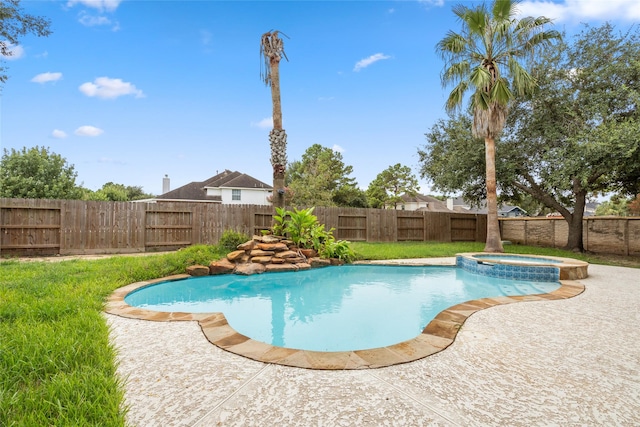 view of pool featuring a patio area, a fenced backyard, and a pool with connected hot tub