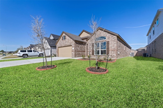 view of front of house with a garage, central AC, and a front lawn