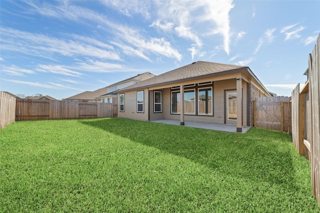 rear view of house featuring a patio and a lawn