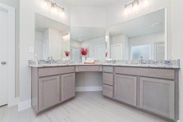 bathroom with walk in shower, tile patterned floors, and vanity