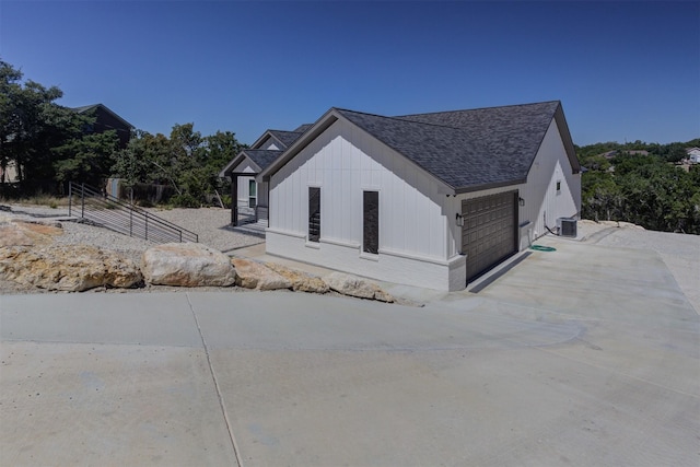 view of home's exterior with a garage and central AC unit