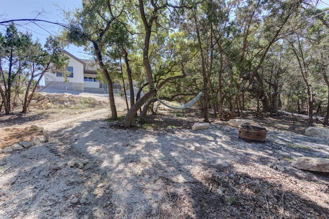 view of yard with a fire pit