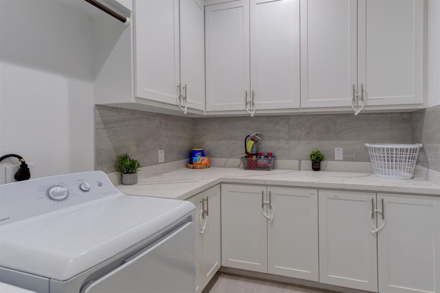 washroom featuring washer / clothes dryer and cabinets