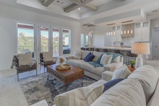 living room featuring beam ceiling, french doors, and coffered ceiling