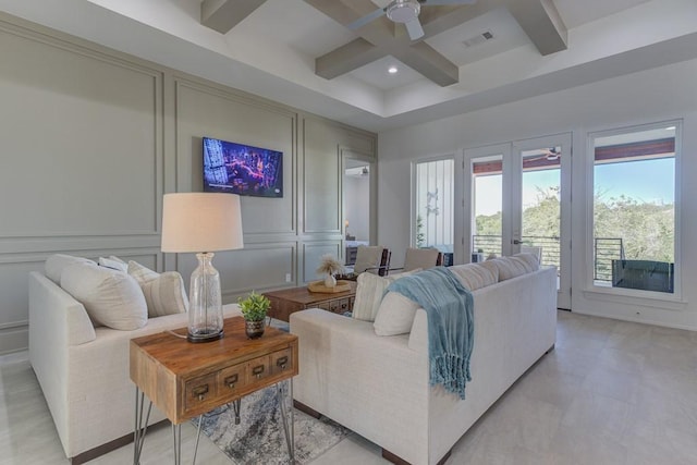 living room with coffered ceiling, french doors, ceiling fan, and beam ceiling