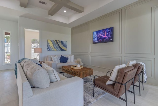 living room with coffered ceiling and beamed ceiling