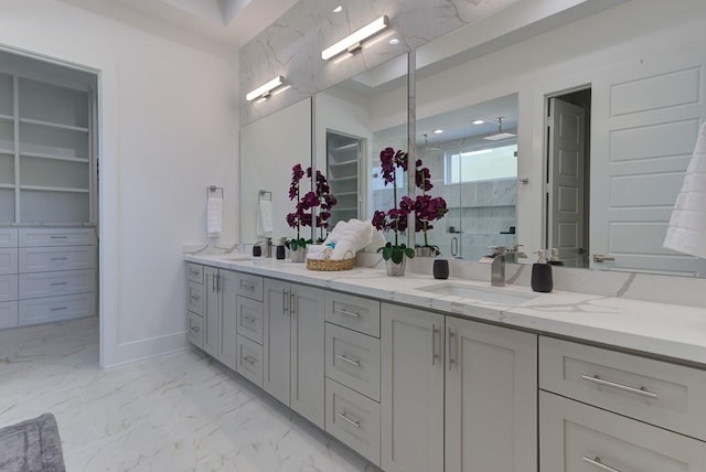 bathroom featuring a shower with shower door and vanity