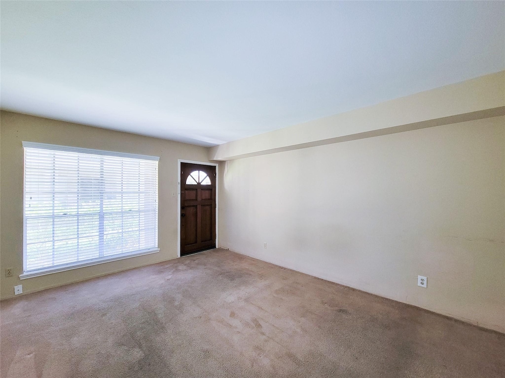 entryway featuring light colored carpet