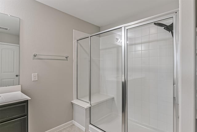 bathroom featuring walk in shower and vanity