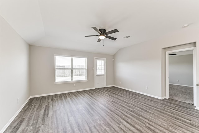 empty room featuring lofted ceiling, ceiling fan, and dark hardwood / wood-style floors