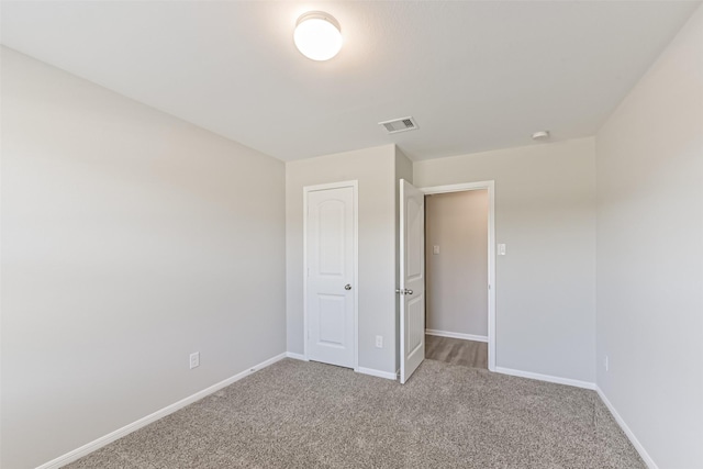 unfurnished bedroom featuring a closet and carpet