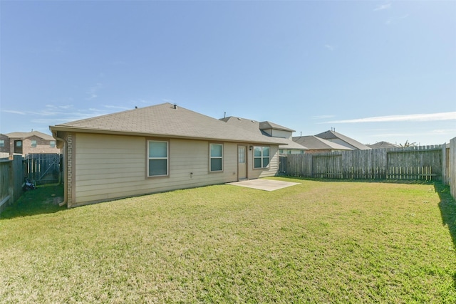 rear view of house with a yard and a patio area