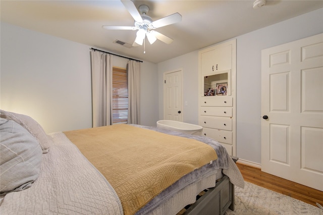 bedroom with ceiling fan and light hardwood / wood-style floors