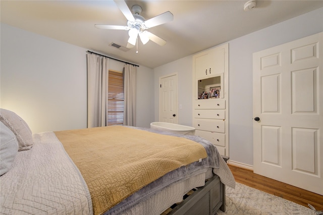 bedroom featuring ceiling fan and light hardwood / wood-style flooring