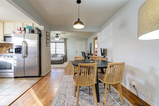 dining room featuring ceiling fan and light hardwood / wood-style floors