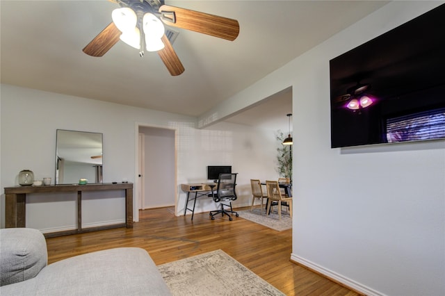 living room with ceiling fan and hardwood / wood-style floors