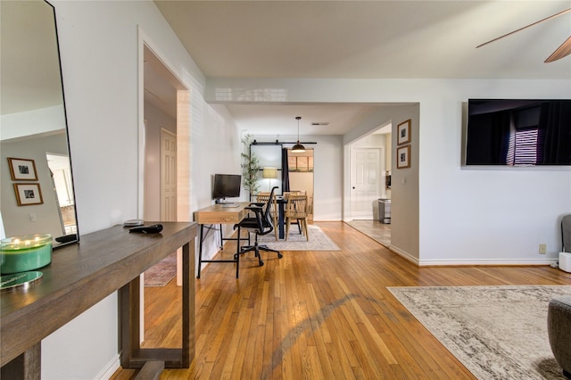 office space with ceiling fan and light hardwood / wood-style floors