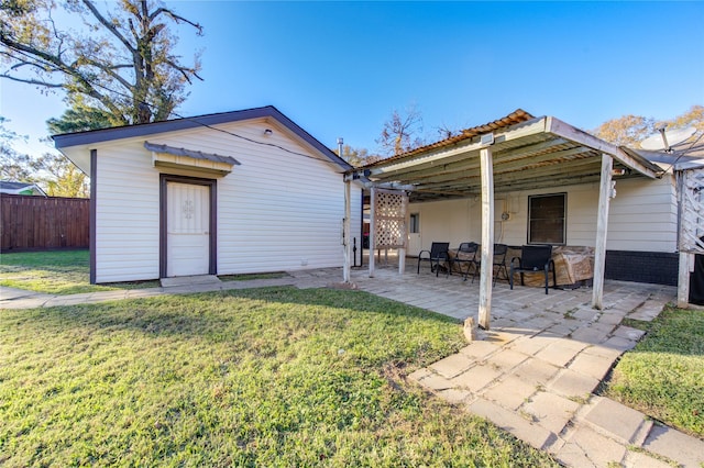 back of house with a yard and a patio