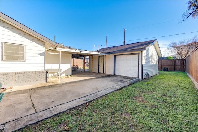 exterior space featuring a garage, a front yard, and a carport