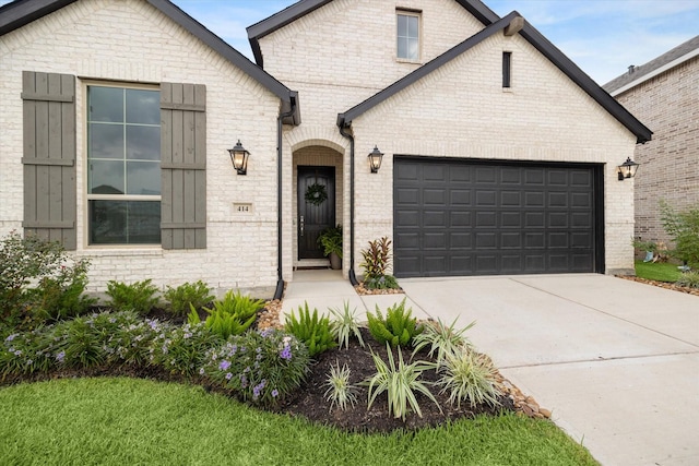 french country style house featuring a garage