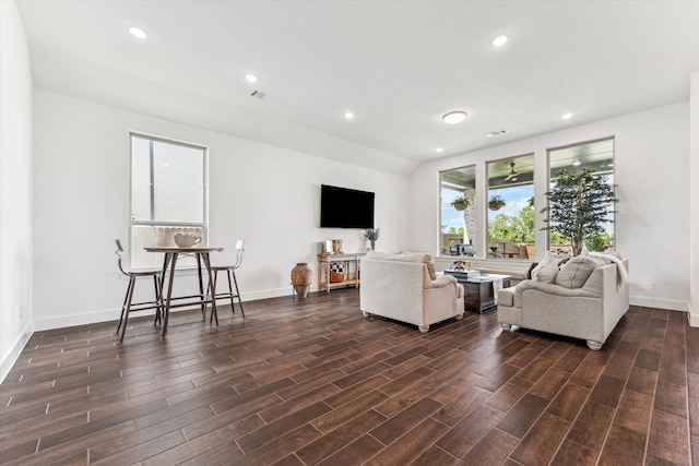 living room featuring vaulted ceiling and a wealth of natural light