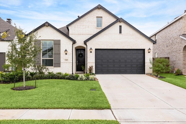 view of front of home featuring a garage and a front lawn