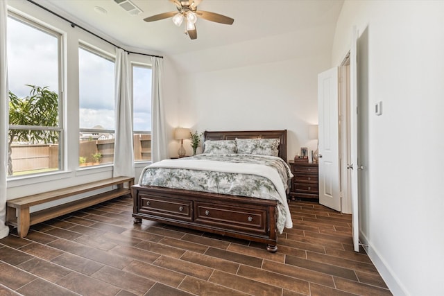 bedroom featuring ceiling fan, multiple windows, and lofted ceiling