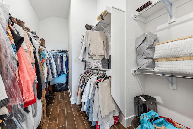 walk in closet featuring lofted ceiling