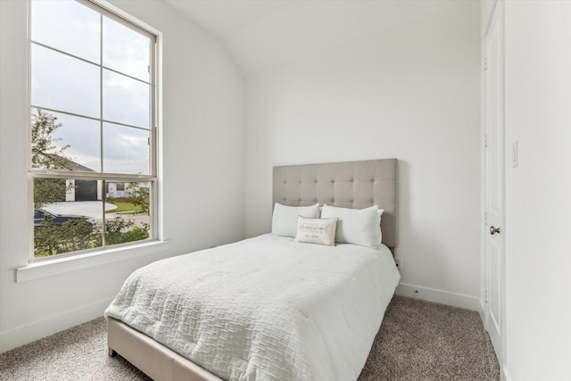 bedroom with carpet flooring and vaulted ceiling