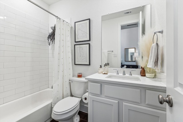 full bathroom featuring shower / tub combo, vanity, and toilet