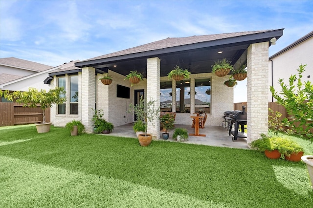 back of house featuring a patio, ceiling fan, and a lawn