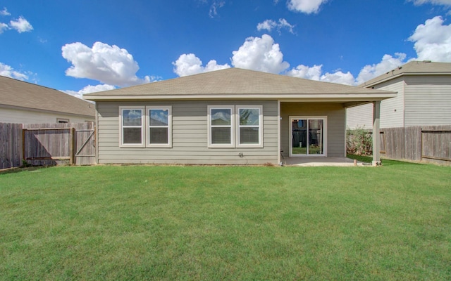 rear view of property with a patio area and a lawn