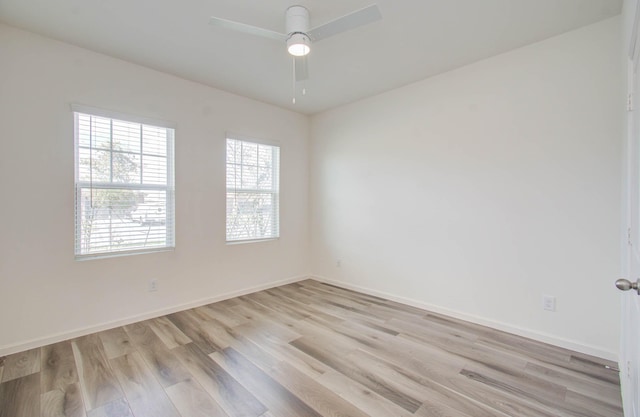 empty room with light wood-type flooring and ceiling fan