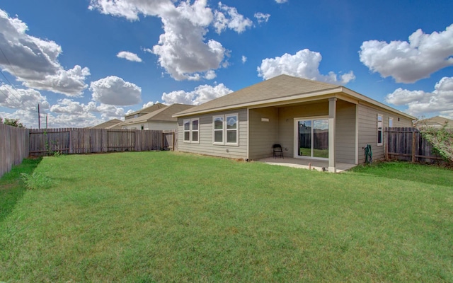 back of house with a yard and a patio area