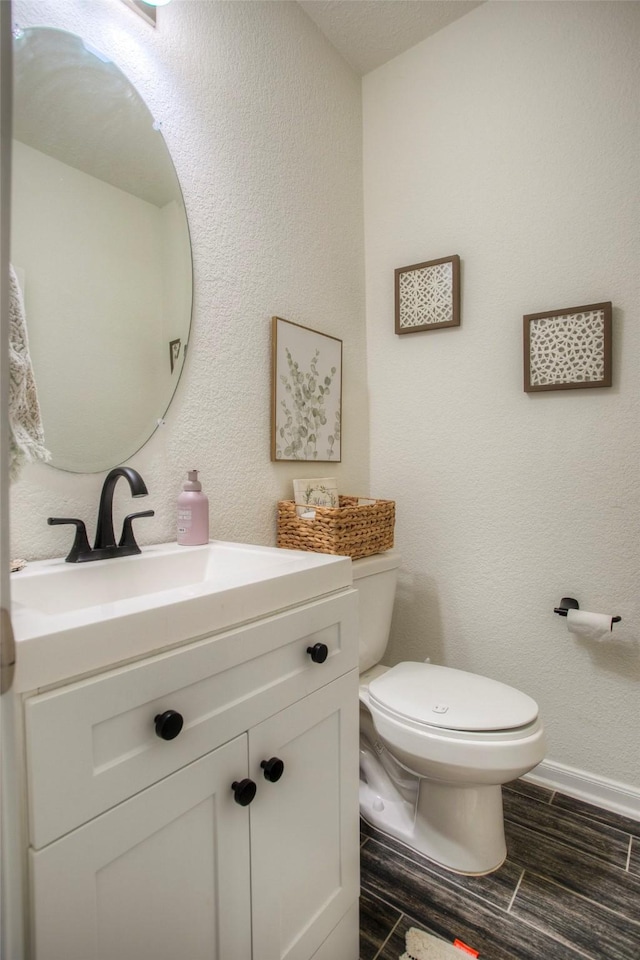 bathroom with toilet and vanity